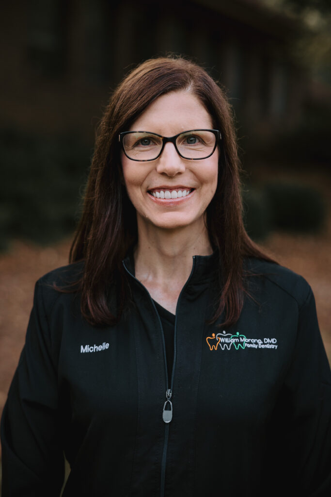 Young female hygienist smiling.