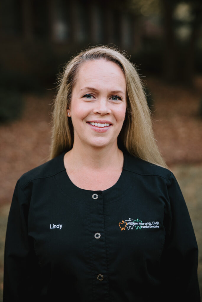 Young female hygienist smiling.